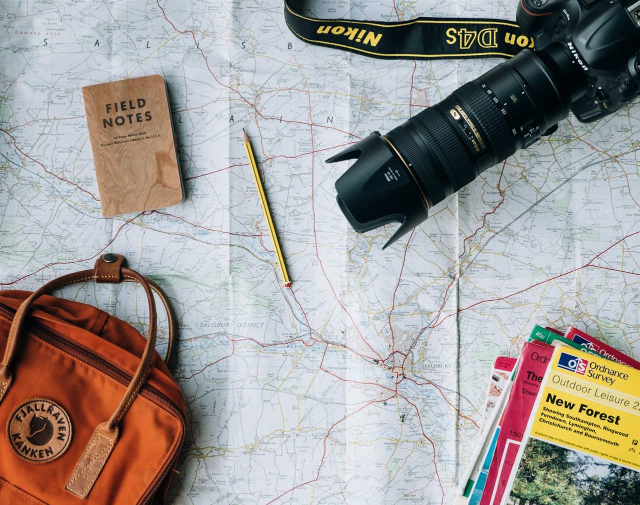 Traveller planning a route on a map with a camera